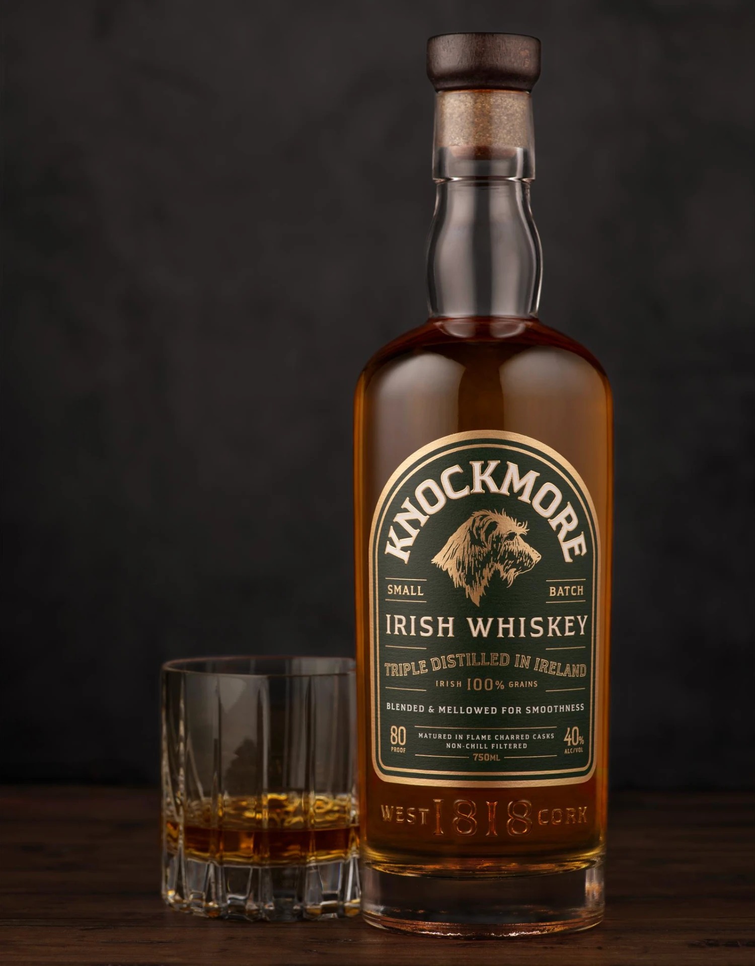 Knockmore Irish Whiskey bottle with a glass of whiskey, label design by CF Napa